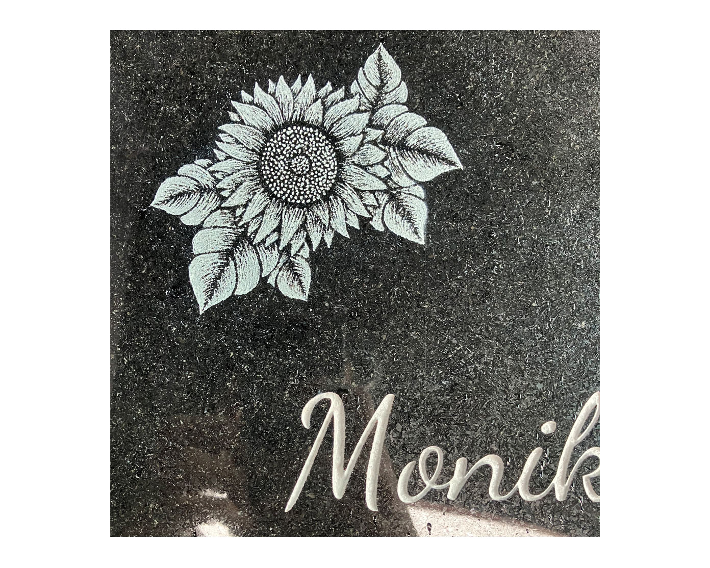 Grabplatte aus schwarzem Granit mit halbplastischer Sonnenblume